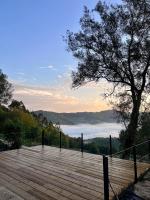 Un paseo marítimo de madera con un árbol y una vista en Aldea Rural y Gastro Restaurante Casona de Labrada, en Labrada