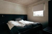 a large bed in a room with a window at Överkalix Jockfall Holiday Home in Jock
