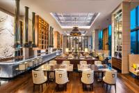 a restaurant with tables and chairs and a bar at The St. Regis Kuala Lumpur in Kuala Lumpur