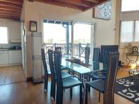 a dining room with a glass table and chairs at Appartement Urrugne, 3 pièces, 6 personnes - FR-1-239-772 in Urrugne