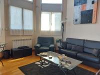 a living room with a couch and a table at Appartement Urrugne, 3 pièces, 6 personnes - FR-1-239-772 in Urrugne