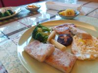 a plate of breakfast food with eggs broccoli and potatoes at Bestime B&amp;B in Jiji