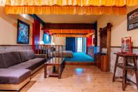 a living room with a couch and a table at 26Life Yunnan Ethnic Creative Inn in Jinghong