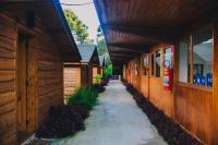 an alley between two wooden buildings with a fire hydrant at Pousada Aberdeen in Campos do Jordão