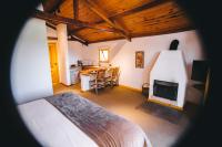 a bedroom with a bed and a fireplace at Pousada Aberdeen in Campos do Jordão