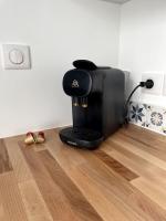 a coffee machine sitting on the floor in a room at Bleu Suprême balnéo in Vierzon
