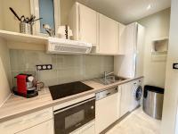 a kitchen with white cabinets and a sink and a dishwasher at Appartement Cannes, 2 pièces, 2 personnes - FR-1-470-27 in Cannes