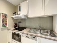 a kitchen with white cabinets and a sink at Appartement Cannes, 2 pièces, 2 personnes - FR-1-470-27 in Cannes