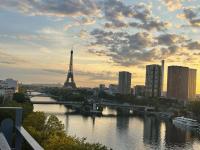 a river with a view of the eiffel tower at Appartement vue Tour Eiffel paris 16 Eme in Paris