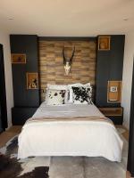 a bedroom with a large bed with a antelope head on the wall at Appartement vue Tour Eiffel paris 16 Eme in Paris