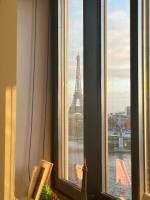 a window with a view of the eiffel tower at Appartement vue Tour Eiffel paris 16 Eme in Paris