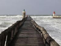 a wooden pier in the ocean with waves at Appartement Capbreton, 2 pièces, 4 personnes - FR-1-239-872 in Capbreton