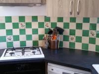 a kitchen with a stove and green and white tiles at Gîte Le Brethon, 5 pièces, 8 personnes - FR-1-489-217 in Le Brethon