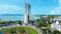 an aerial view of a city with a tall building at HARRIS Hotel Batam Center in Batam Center