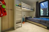 a small bedroom with a bunk bed and a window at Camping U Pirellu in Porto-Vecchio