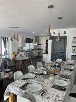 a kitchen with a long table with plates on it at Les Chalets Baie Cascouia in Lac Kénogami