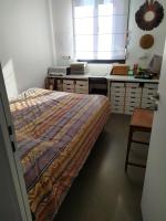 a bedroom with a bed and a desk and a window at Appartement de 2 chambres avec vue sur la ville terrasse amenagee et wifi a Saint Ouen in Saint-Ouen