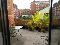 a balcony with a table and potted plants at Appartement de 2 chambres avec vue sur la ville terrasse amenagee et wifi a Saint Ouen in Saint-Ouen