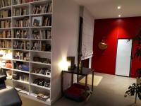 a living room with a book shelf filled with books at Appartement de 2 chambres avec vue sur la ville terrasse amenagee et wifi a Saint Ouen in Saint-Ouen