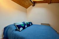 a bedroom with a blue bed with pillows at Apartment with balcony and exceptional view in Saint-Gervais-les-Bains