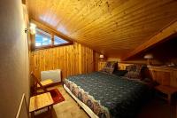 a bedroom with a bed in a wooden cabin at Apartment with balcony and exceptional view in Saint-Gervais-les-Bains