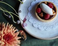 a plate with a bowl of fruit and a spoon at The North Branch Inn in North Branch
