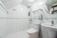 a white bathroom with a toilet and a sink at 自由之丘民宿 l 寵物友善 in Taitung City