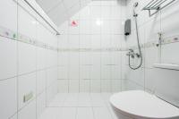 a white bathroom with a toilet and a shower at 自由之丘民宿 l 寵物友善 in Taitung City