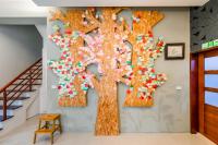 a tree made out of puzzle pieces on a wall at 自由之丘民宿 l 寵物友善 in Taitung City