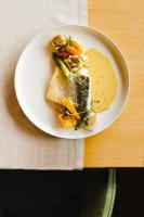 a white plate of food on a table at Logis Hotel Le Relais De La Poste Restaurant Le Fil du Temps in Thury-Harcourt