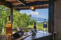 a table with two bottles and glasses of wine at Camping U Pirellu in Porto-Vecchio