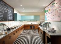 a large kitchen with a black and white checkered floor at Hyatt Place LAX/Century BLVD in Los Angeles