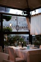 a table with wine glasses on it in a restaurant at Al Pescatore - B&B in Bari