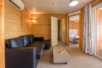 a living room with a leather couch and a table at Camping U Pirellu in Porto-Vecchio
