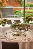 a table with white tables with glasses and flowers at Hotel du Vin Exeter in Exeter