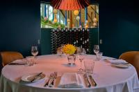 a table with a white table cloth and wine glasses at Hotel du Vin Exeter in Exeter
