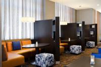a waiting room with orange and blue chairs and tables at Courtyard by Marriott Birmingham Downtown at UAB in Birmingham