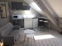 a kitchen and a living room with a couch and a table at Studio étage 3, proche Techn&#39;hom, IUT et UTBM in Belfort