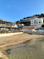 a view of the beach with buildings in the background at L&#39;Annexe de la Madrague Marseille in Marseille