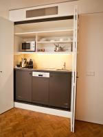 a room with a kitchen with a large pantry at CORTIINA Hotel in Munich