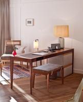 an office with a desk and a chair with a lamp at Louis Hotel in Munich