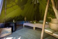 a room with a tent with a bed and a rug at Camping U Pirellu in Porto-Vecchio