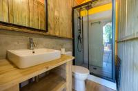 a bathroom with a sink and a toilet at Camping U Pirellu in Porto-Vecchio