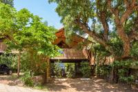 a tree house with a deck on top of it at Camping U Pirellu in Porto-Vecchio