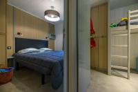 a bedroom with a blue bed and a ladder at Camping U Pirellu in Porto-Vecchio