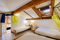 two beds in a room with wooden ceilings at Villa Provence Vue Panoramique - in Fayence