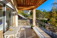 a patio with a table and chairs on a balcony at Villa Provence Vue Panoramique - in Fayence