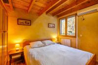 a bedroom with a bed with two tables and two lamps at Villa Provence Vue Panoramique - in Fayence