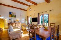 a kitchen and living room with a wooden table at Villa Provence Vue Panoramique - in Fayence
