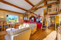 a living room and kitchen with wooden ceilings at Villa Provence Vue Panoramique - in Fayence